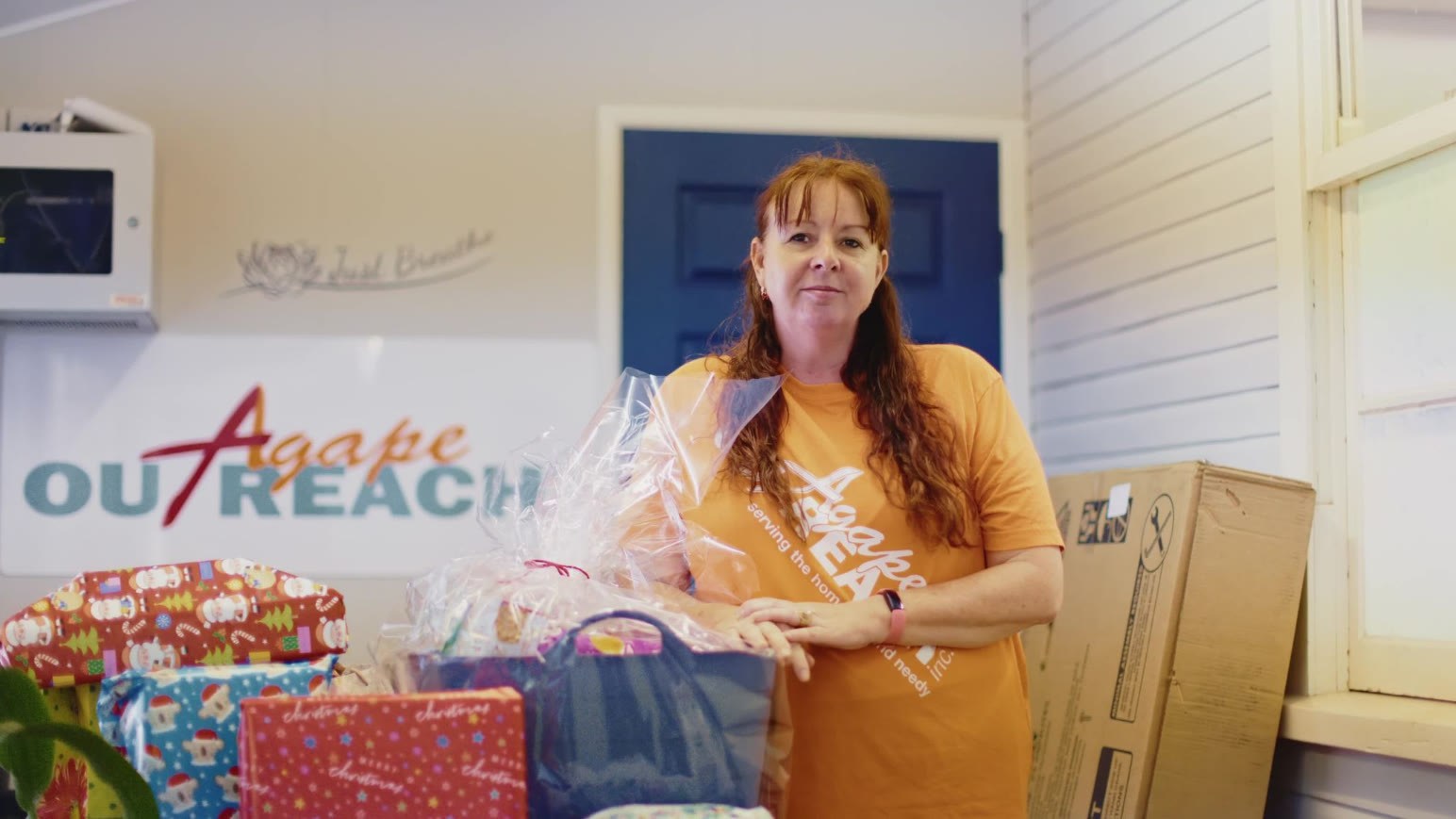 Theresa Mitchell of Agape Outreach with Christmas hampers at the Agape Hub in Tweed Heads