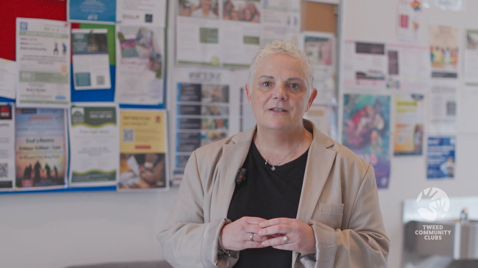 Jo Blanchard of The Family Centre speaking in front of a community noticeboard
