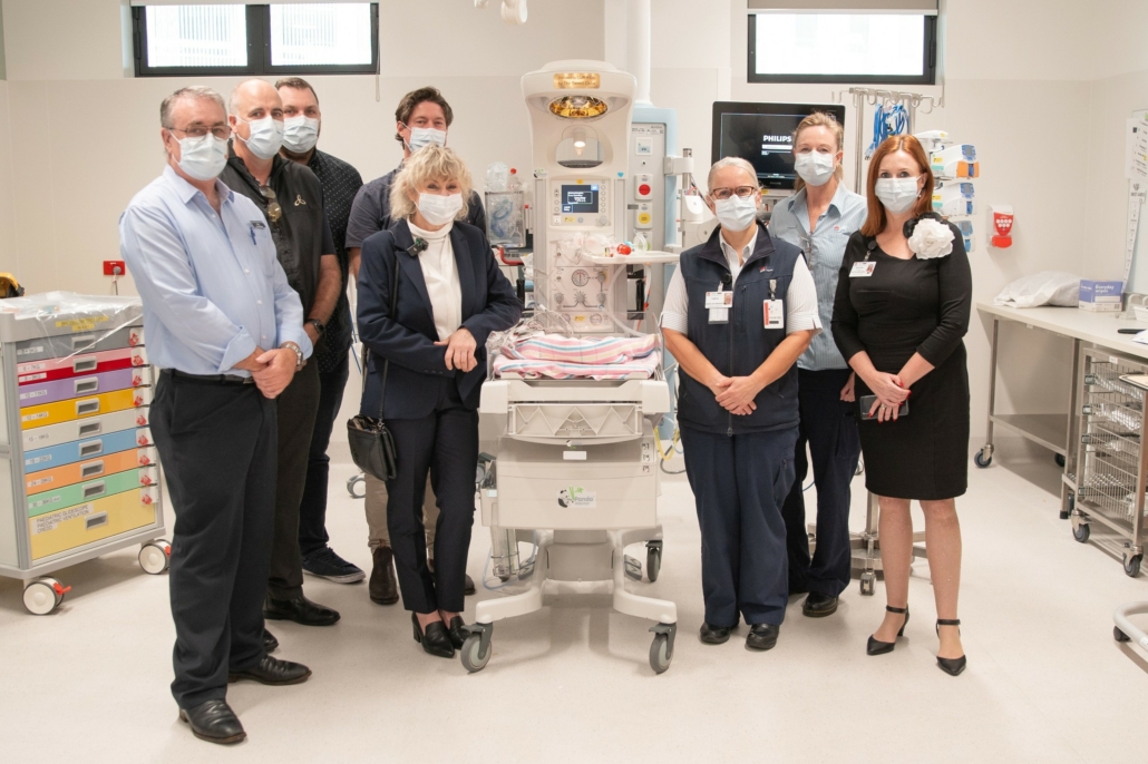 Representatives gathered around new neonatal equipment in the PANDA special care nursery